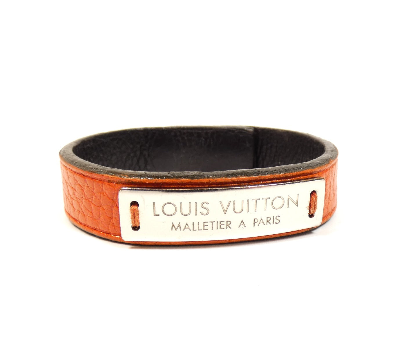 LOUIS VUITTON logo on black surface. Louis Vuitton Malletier